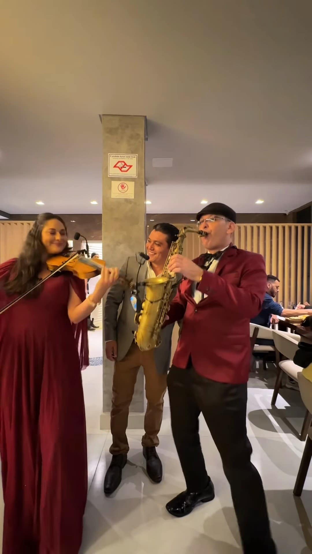 Violinista e saxofonistas tocando no salão na noite de inauguração